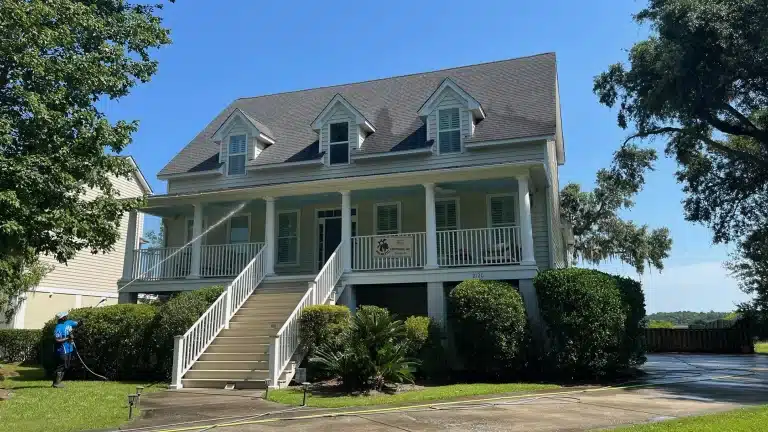 Triple J technician house washing a two-story Lowcountry home